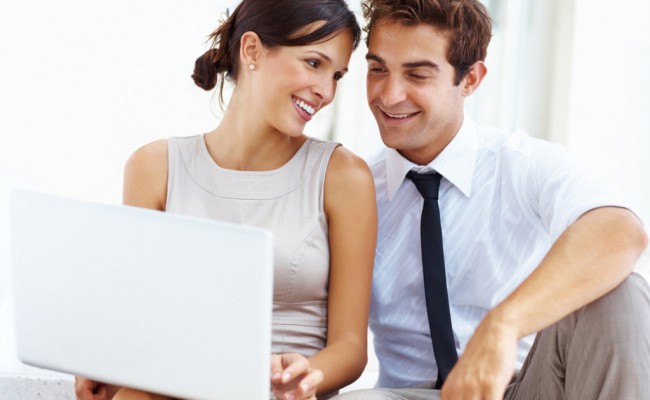 Young business couple working on laptop